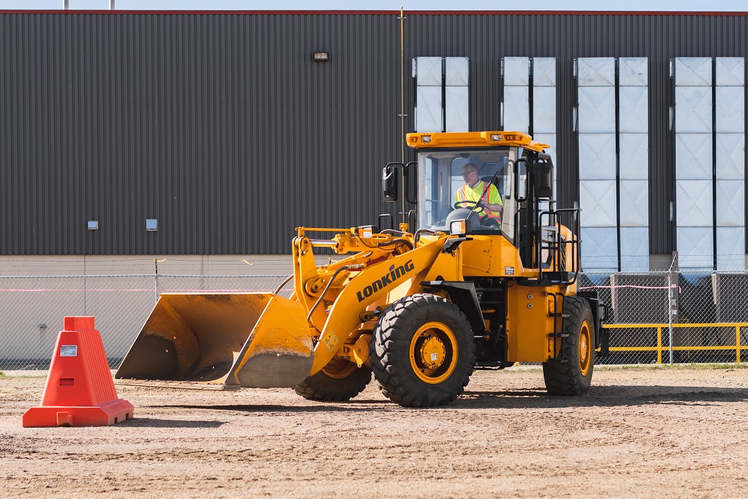 student operating a wheel loader